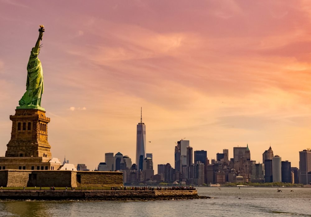 A beautiful picture of a statue of liberty national monument under the mesmerizing sunset in New York City, USA